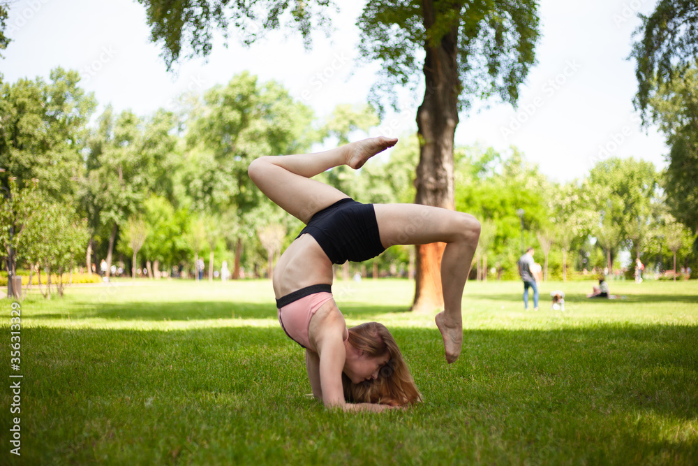 Girl is practicing yoga in the park. Healthy lifestyle.
Girl is practicing yoga in the park. Healthy lifestyle.