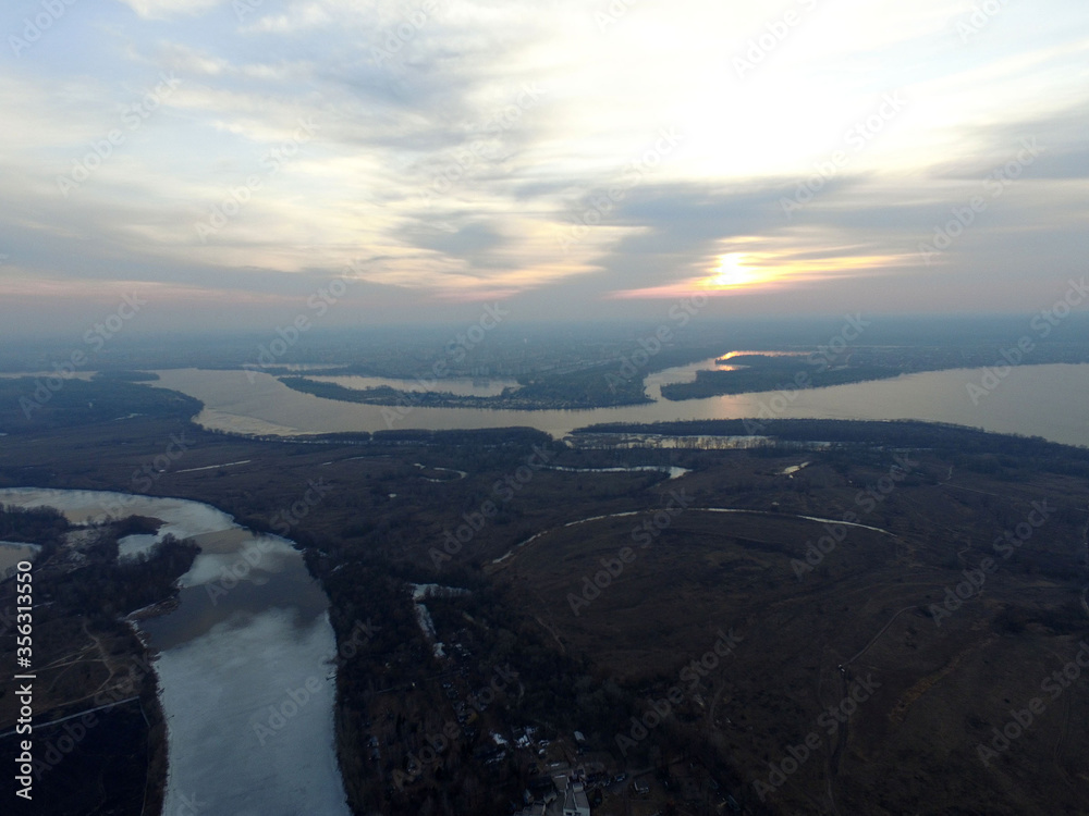 Aerial view of the countryside (drone image).Near river Desna.Winter time.Sunset. Near Kiev,Ukraine