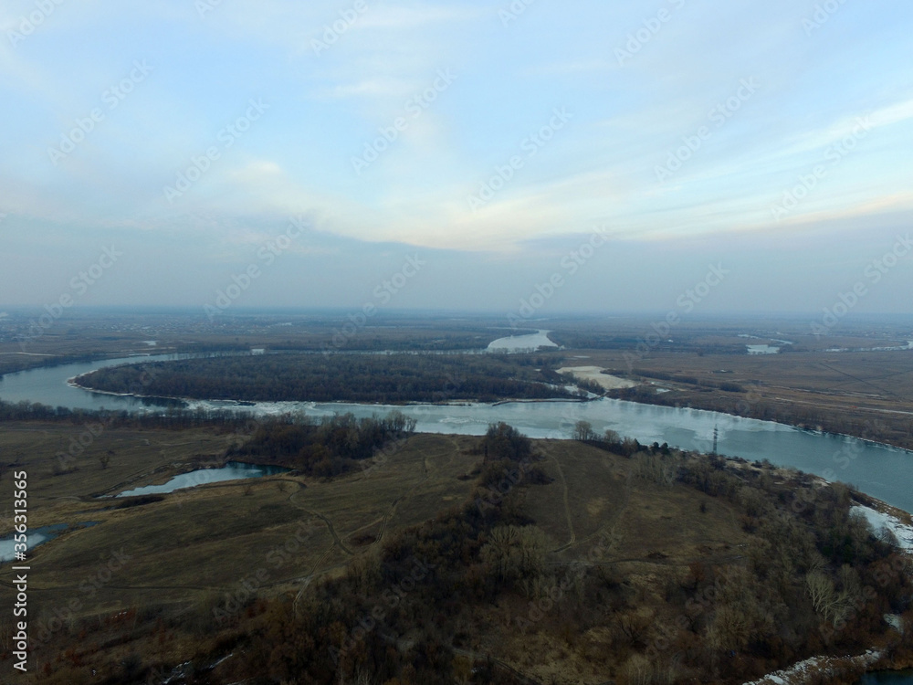Aerial view of the countryside (drone image).Near river Desna.Winter time.Sunset. Near Kiev,Ukraine Aerial view of the countryside (drone image).Near river Desna.Winter time.Sunset. Near Kiev,Ukraine
