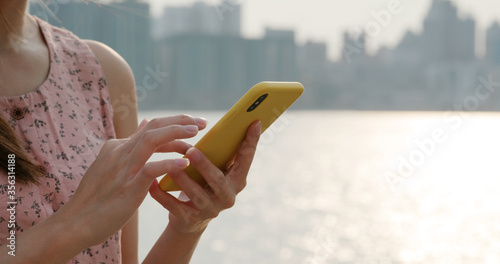 Photography Woman uses mobile phone at street