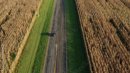 AERIAL MS Man riding motorcycle on rural road  / Plattsburg, Missouri, USA photo