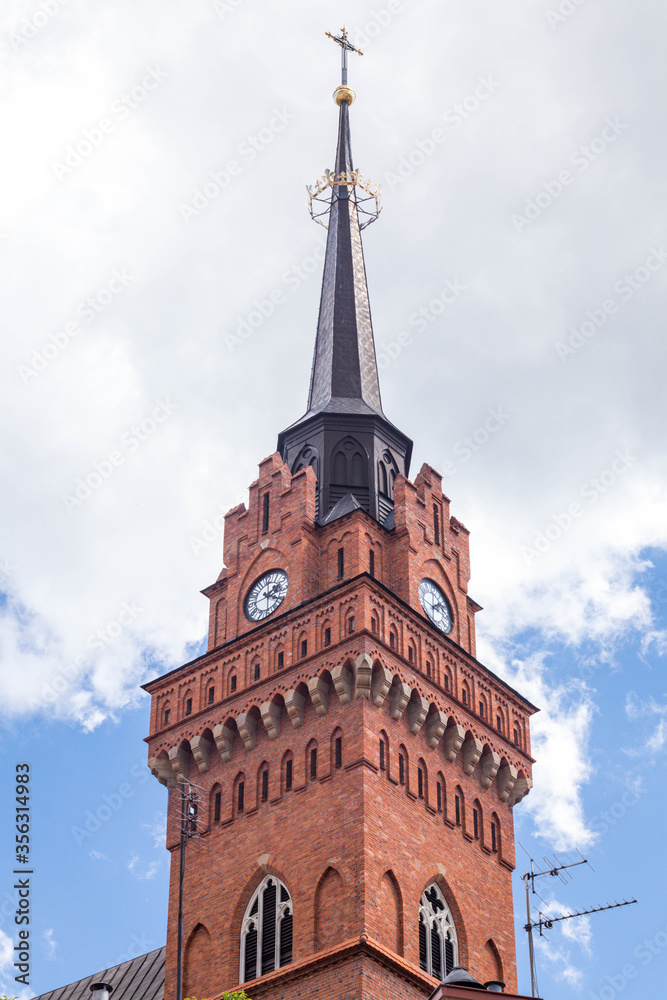 Old, renaissance cathedral clock tower in Tarnow, Poland, June 2020