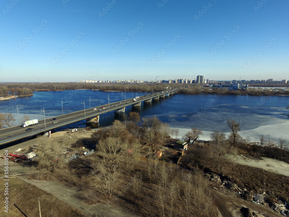 Moscow Bridge across Dnepr River, photo from drone at winter. Kiev