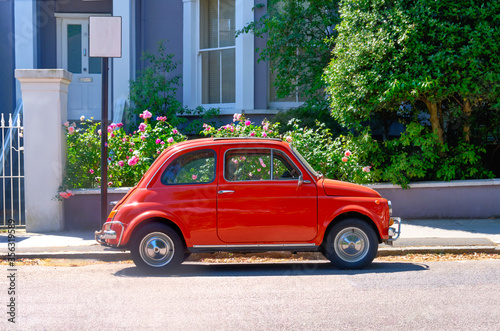 Canvas Print Classic Fiat 500 parked outside Terrace Houses.
