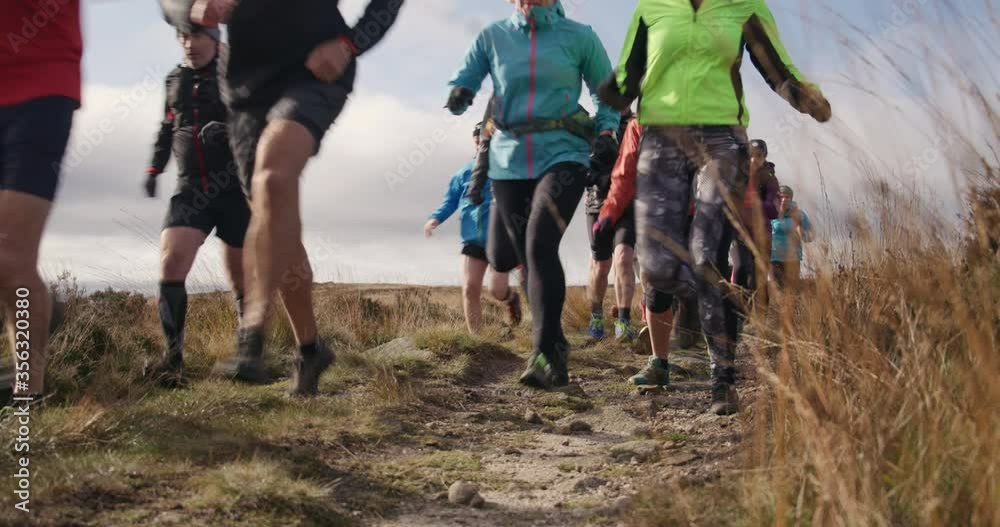 MS Group of people running in landscape / Yorkshire Moors, Yorkshire, UK MS Group of people running in landscape / Yorkshire Moors, Yorkshire, UK
