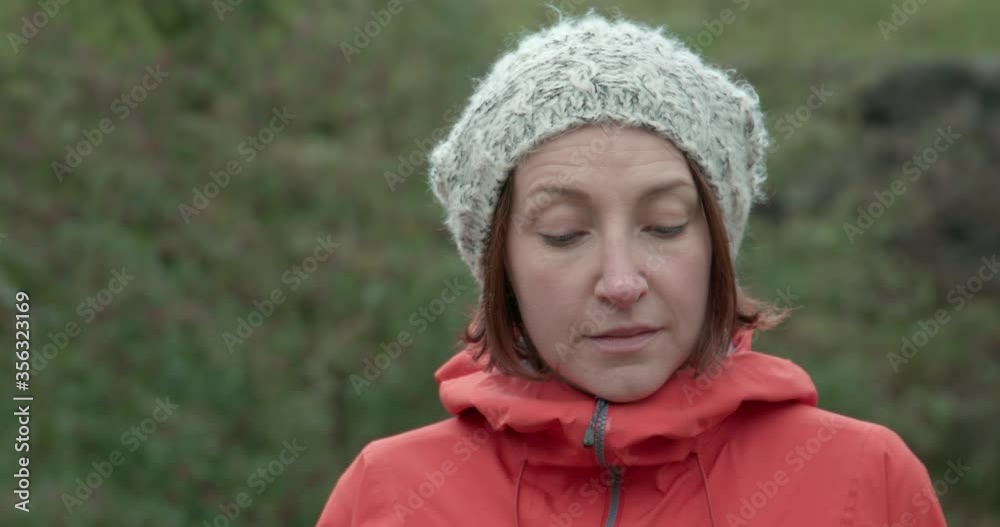 CU Portrait of smiling woman in knit hat outdoors / Yorkshire Moors, Yorkshire, UK CU Portrait of smiling woman in knit hat outdoors / Yorkshire Moors, Yorkshire, UK