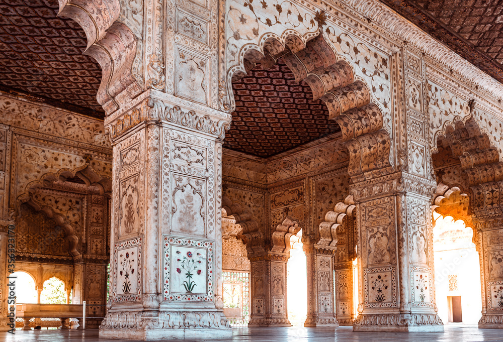 Architectural details and traditional patterns on white marble arches and pillars inside the famous historic monument of India. Hall of private audience of Mughal emperor at Red Fort Delhi, India.