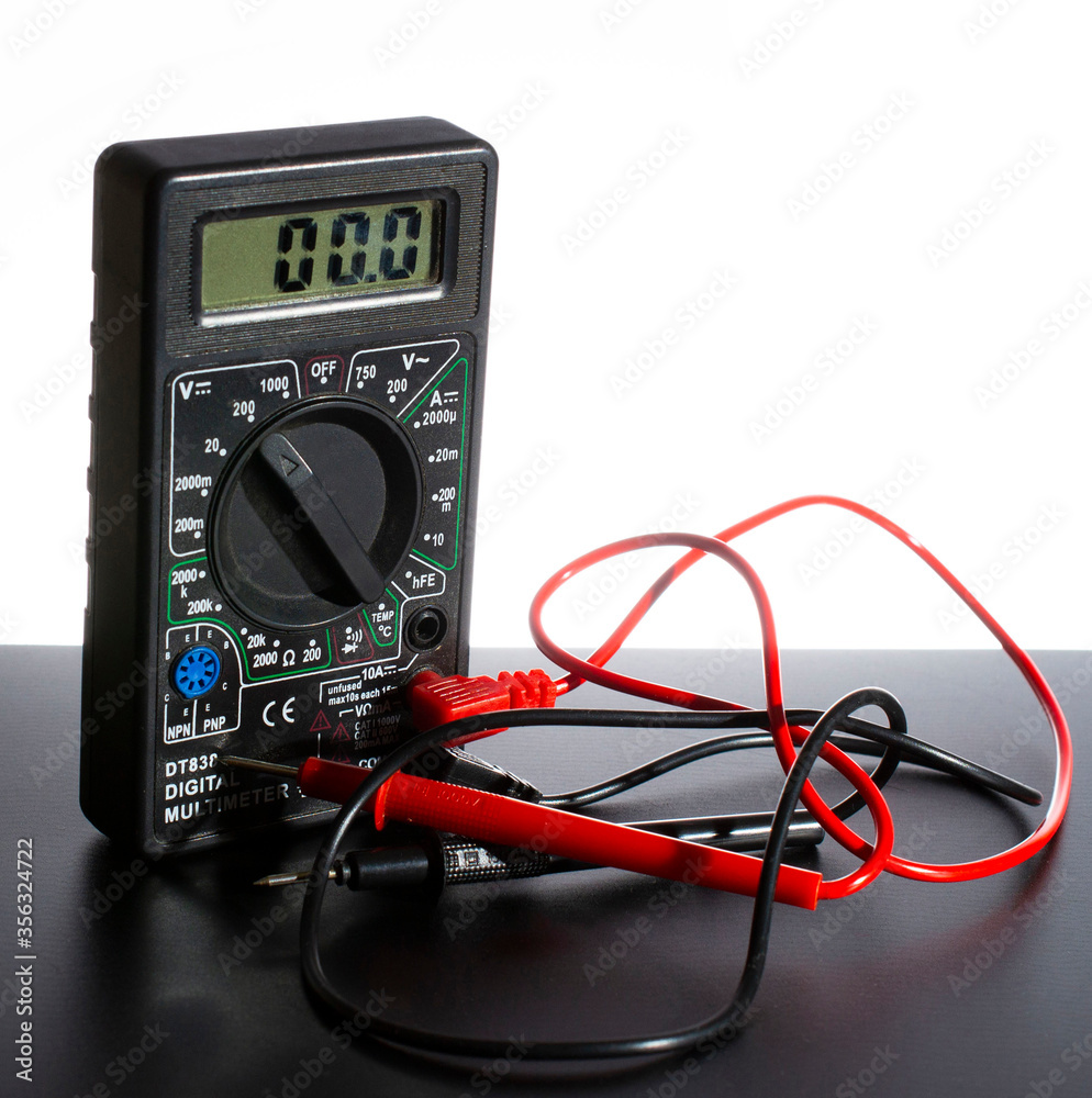 Digital multimeter with probes on a white-black background. close-up. Digital multimeter with probes on a white-black background. close-up.