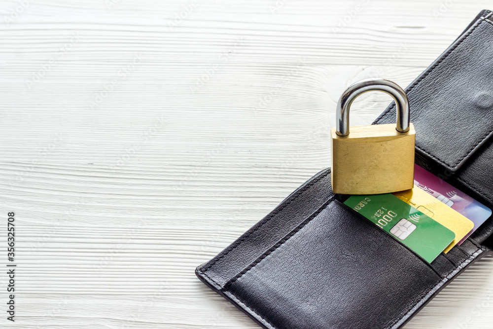 Naklejka premium Credit card data security concept with lock on white wooden table copyspace