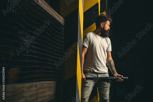 Energy and fashion. Power and energy concept. Sport equipment. Gangster with bat weapon. Feel my strength. Bearded man with baseball bat. Handsome man hand holds baseball sport bat.