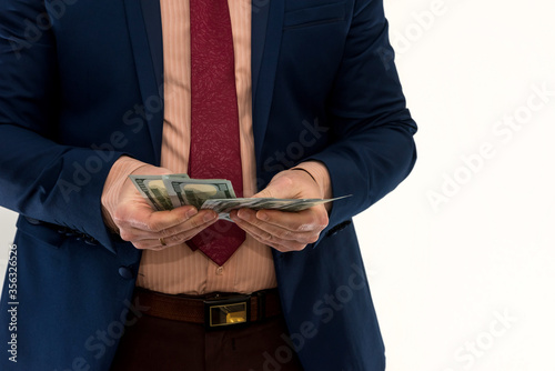 Businessman counts money isolated on white. A man in a suit is making a profit or a win. Account of dollars. Wealth concept.