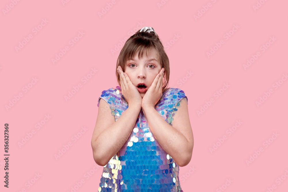 portrait of an anxious young girl looking at the camera with her eyes wide open portrait of an anxious young girl looking at the camera with her eyes wide open