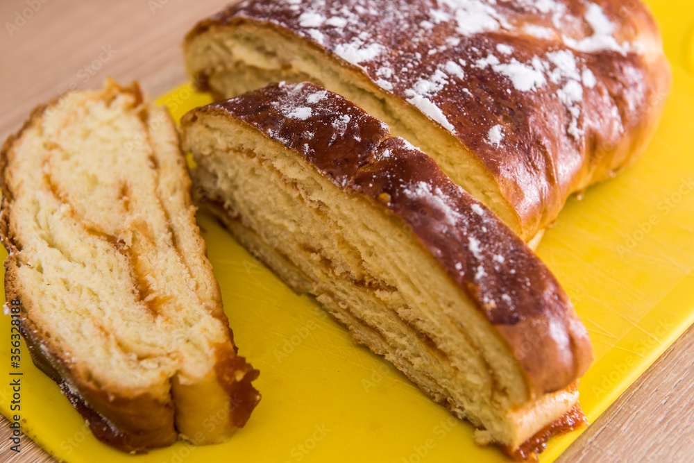 Sweet pastry, pie bun with red sweet strawberry jam inside slices of dessert with powder Sweet pastry, pie bun with red sweet strawberry jam inside slices of dessert with powder