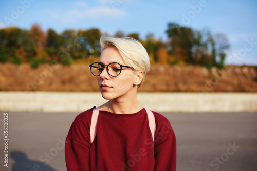 Caucasian millennial female posing on copy space background 
