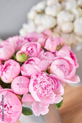 Fototapeta Naklejka Na Ścianę i Meble -  Different varieties of peonies in a metal vases. Beautiful peony flower for catalog or online store. Floral shop concept . Beautiful fresh cut bouquet. Flowers delivery