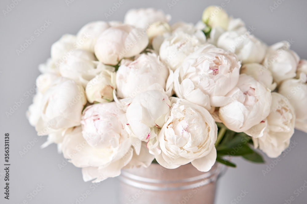 White Odile peonies in a metal vase. Beautiful peony flower for catalog or online store. Floral shop concept . Beautiful fresh cut bouquet. Flowers delivery. Copy space
