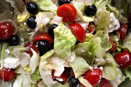 closeup of tomato, onions and black olives salad washed and cut ready to be eaten