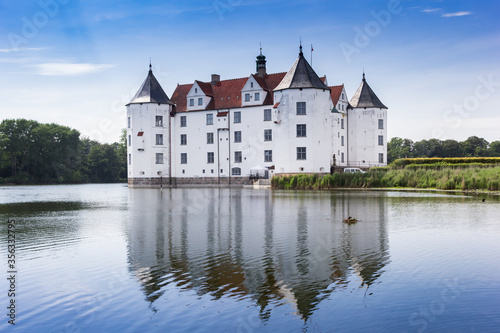 Historic castle with reflection in the lake in Glucksburg, Germany © venemama