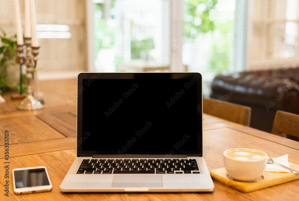 Mockup of laptop computer with empty screen with coffee cup and smartphone on table of the coffee shop background,black screen Mockup of laptop computer with empty screen with coffee cup and smartphone on table of the coffee shop background,black screen