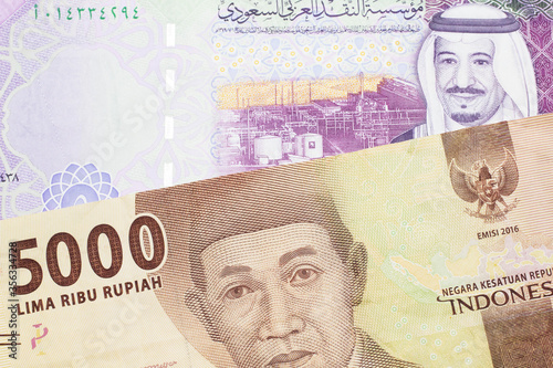 Wallpaper Mural An orange five thousand Indonesian rupiah bank note with a five riyal note from Saudi Arabia Torontodigital.ca