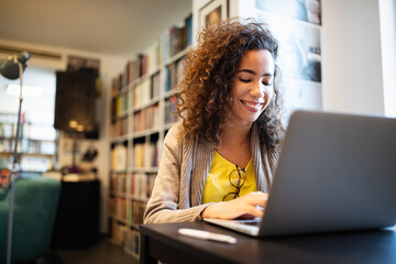 Beautiful happy woman using notebook. Study, learning, university concept