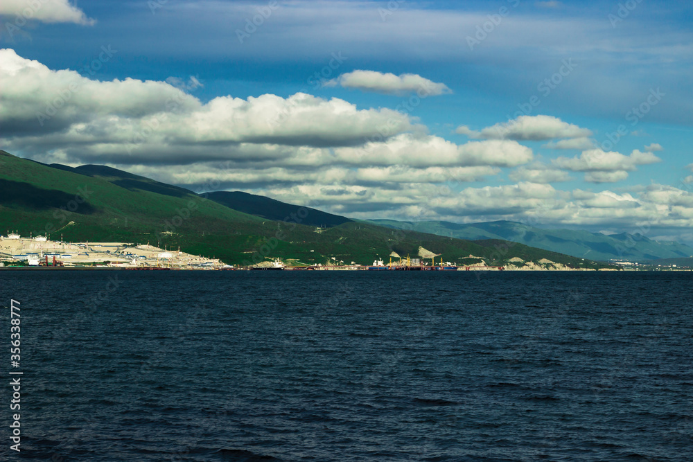 View at green mountain an sea cost and Novorossiysk oil port at sunny day.