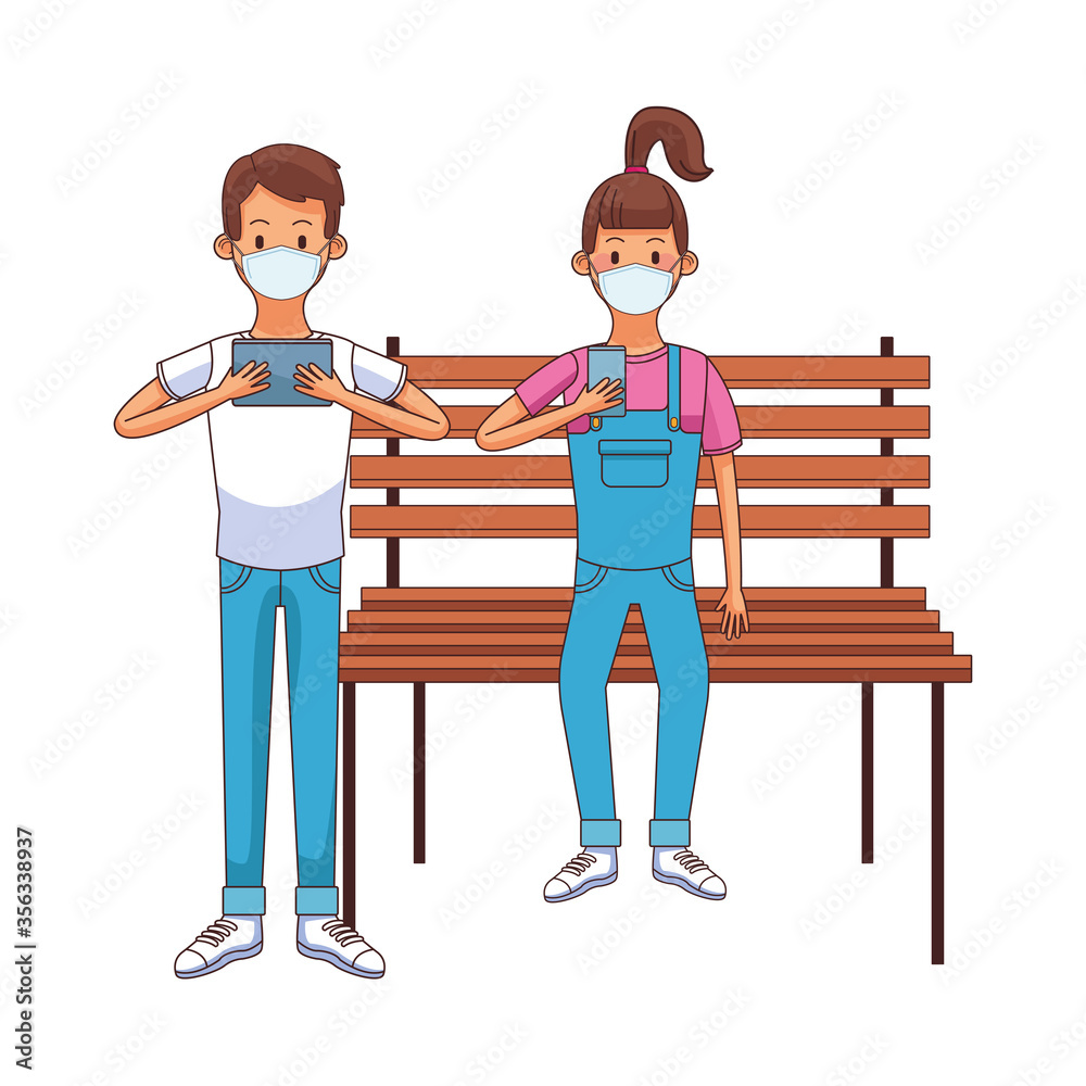 young couple wearing medical mask using technology seated in park chair