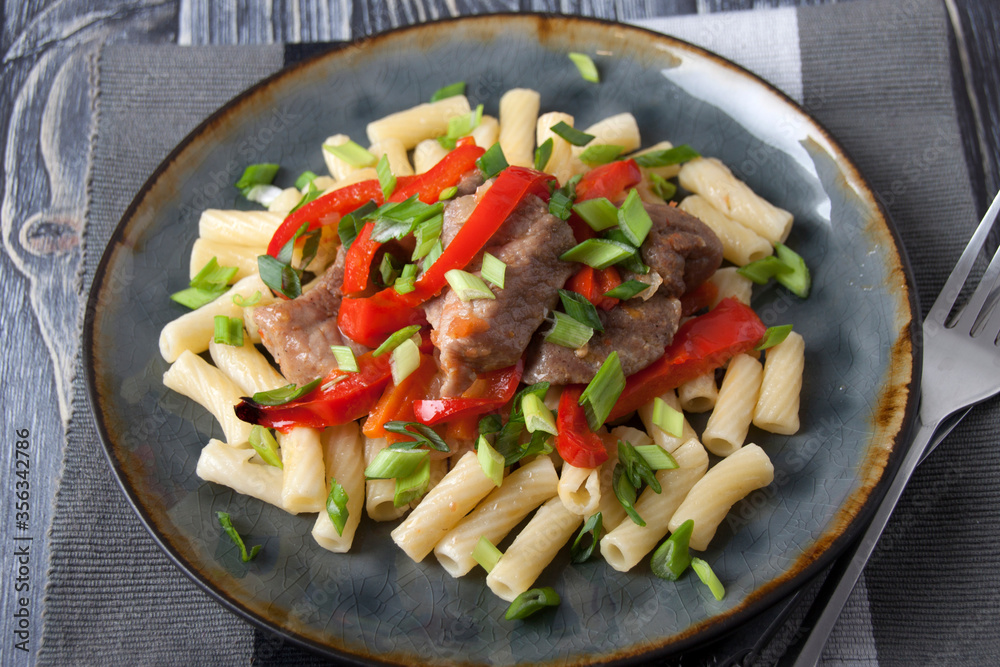 Meat dish with red pepper and pasta Meat dish with red pepper and pasta