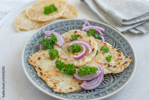 Onion naan - traditional indian bread. pita bread or scones with green onions