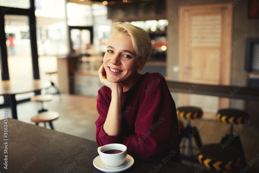 Caucasian young female enjoying cappuccino drink in coffee shop Caucasian young female enjoying cappuccino drink in coffee shop