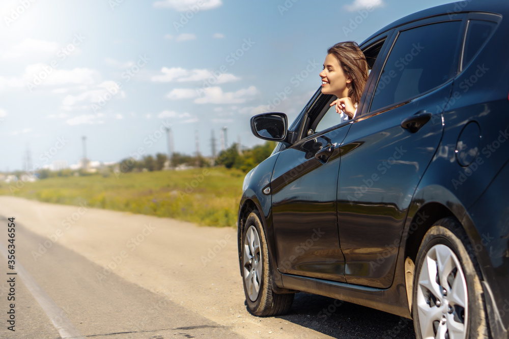 Happy business woman driving a car.