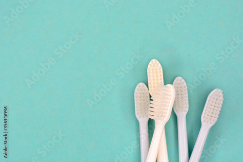 Clean toothbrushes laid out on the background for inscription text about oral...