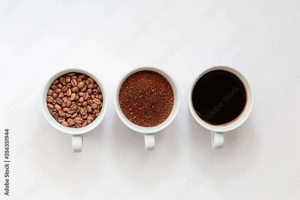 Flat lay view of, coffee beans, grinded coffee and ready to drink coffee in a cup Flat lay view of, coffee beans, grinded coffee and ready to drink coffee in a cup