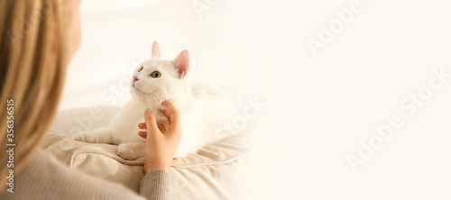 Young woman with her beautiful pet at home  space for text. Banner design