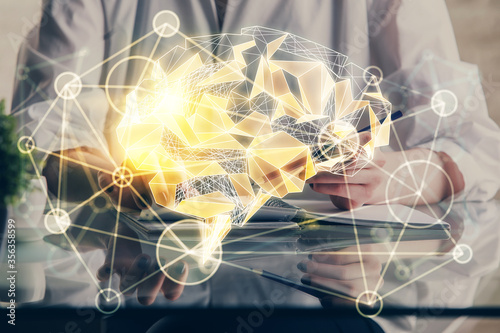 Multi exposure of writing hand on background with brain hologram. Concept of self learning.