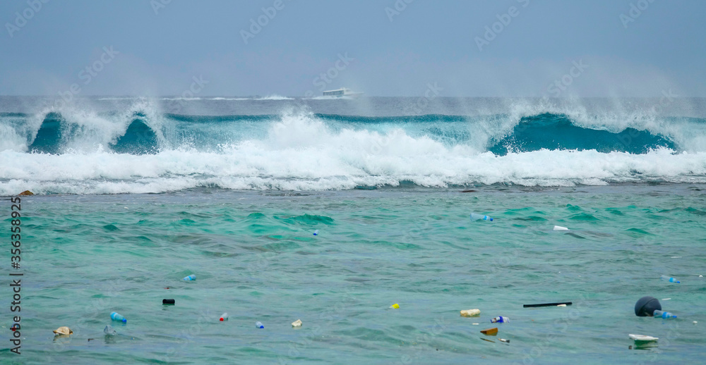 Fototapeta premium Big barrel wave crashing toward the coast brings more litter to exotic island.