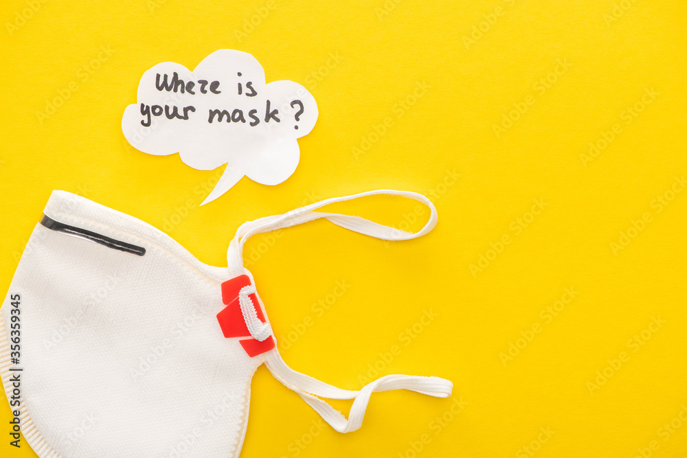 top view of safety mask with speech bubble on yellow background