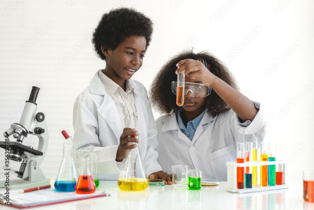 Two african american cute little boy and girl student child learning