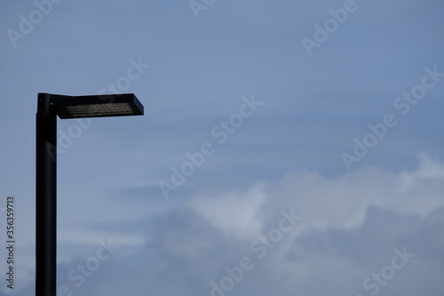 Isolated LED lamppost and cloudy sky