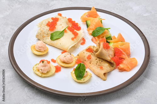 Russian pancakes with salmon and red caviar