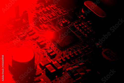 chip on a computer board in red tinted photo