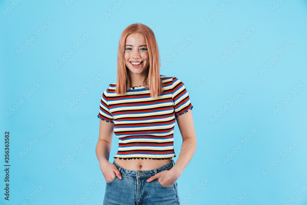Image of joyful girl in striped t-shirt looking and smiling at camera Image of joyful girl in striped t-shirt looking and smiling at camera