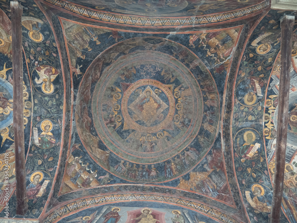 Frescoes on the ceiling of portico, the front part of Cozia monastery. The well-preserved religious architecture from 14th century in Romania.