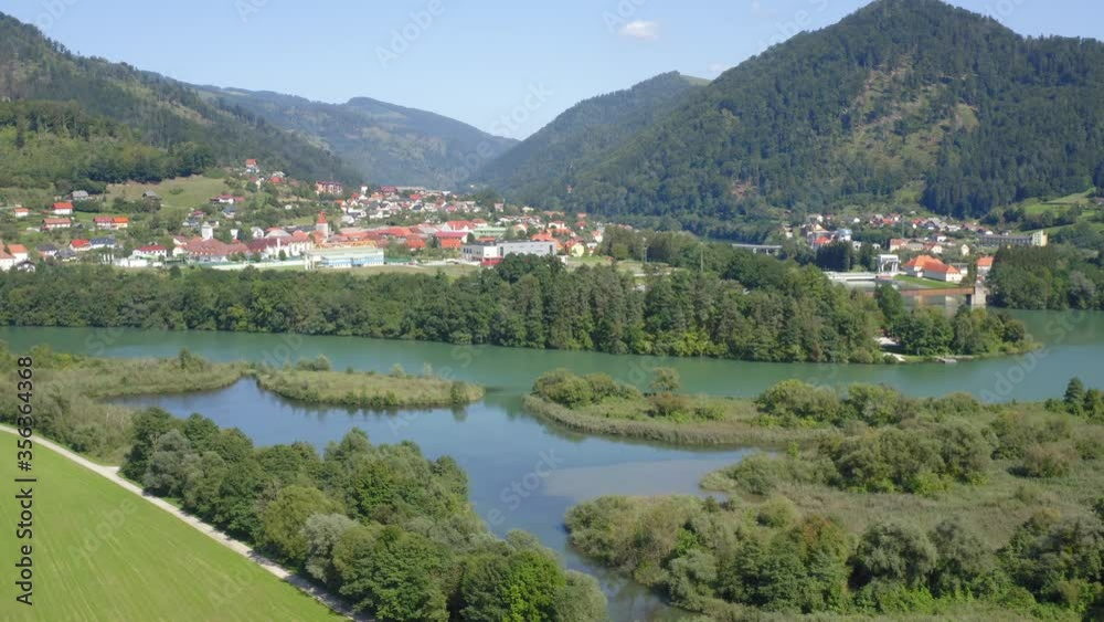 Lush vegetation surrounding Lake Dravograd and rolling mountains Lush vegetation surrounding Lake Dravograd and rolling mountains
