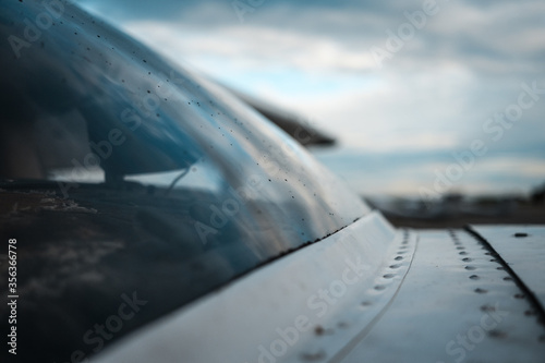 Rain drops on the windshield of small general aviation airplane. photo