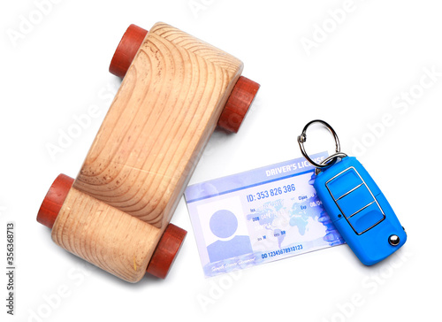 Driving license with car key on white background photo