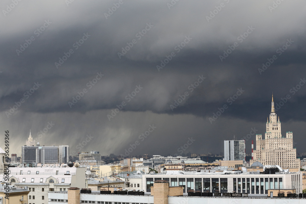 urban cityscape panorama day view of buildings, monuments, roofs, rooftops on a dark stormy sky and black rain clouds background. Moscow, Russia