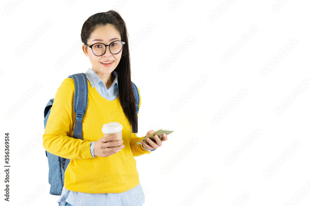 Portrait of a happy friendly casual girl student asian in glasses with backpack holding coffee while standing and mobile phone isolated over white background Portrait of a happy friendly casual girl student asian in glasses with backpack holding coffee while standing and mobile phone isolated over white background
