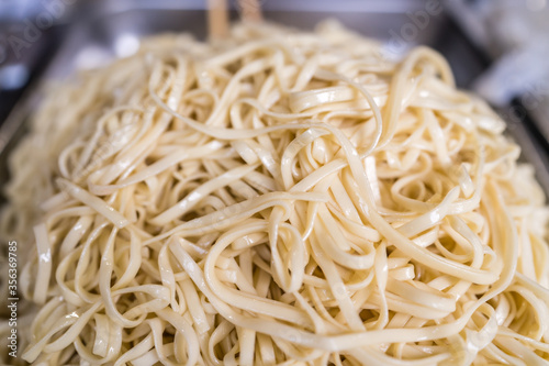 Closeup shot of noodles in a pot in China with a blurred background