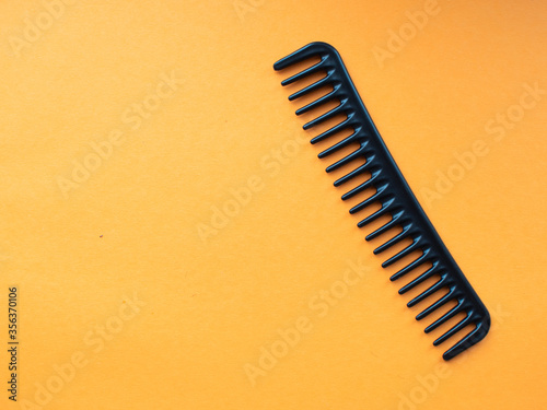 set of professional hairdressing accessories on orange background. space for text. the view from the top